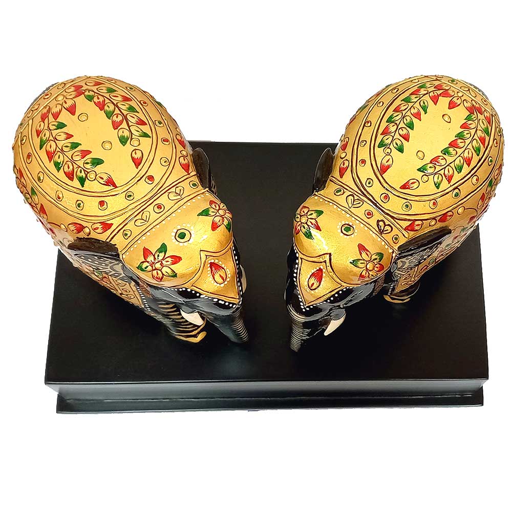 A handcrafted wooden elephant memento, perfect as a souvenir or keepsake.