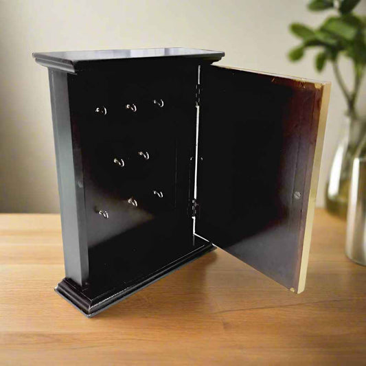 Handcrafted wooden key organizer featuring ornate brass work on the front panel, combining style and function.