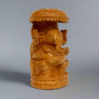 Elegant wooden Ganesha statue featuring unique umbrella design and detailed carvings, symbolizing good luck and positivity