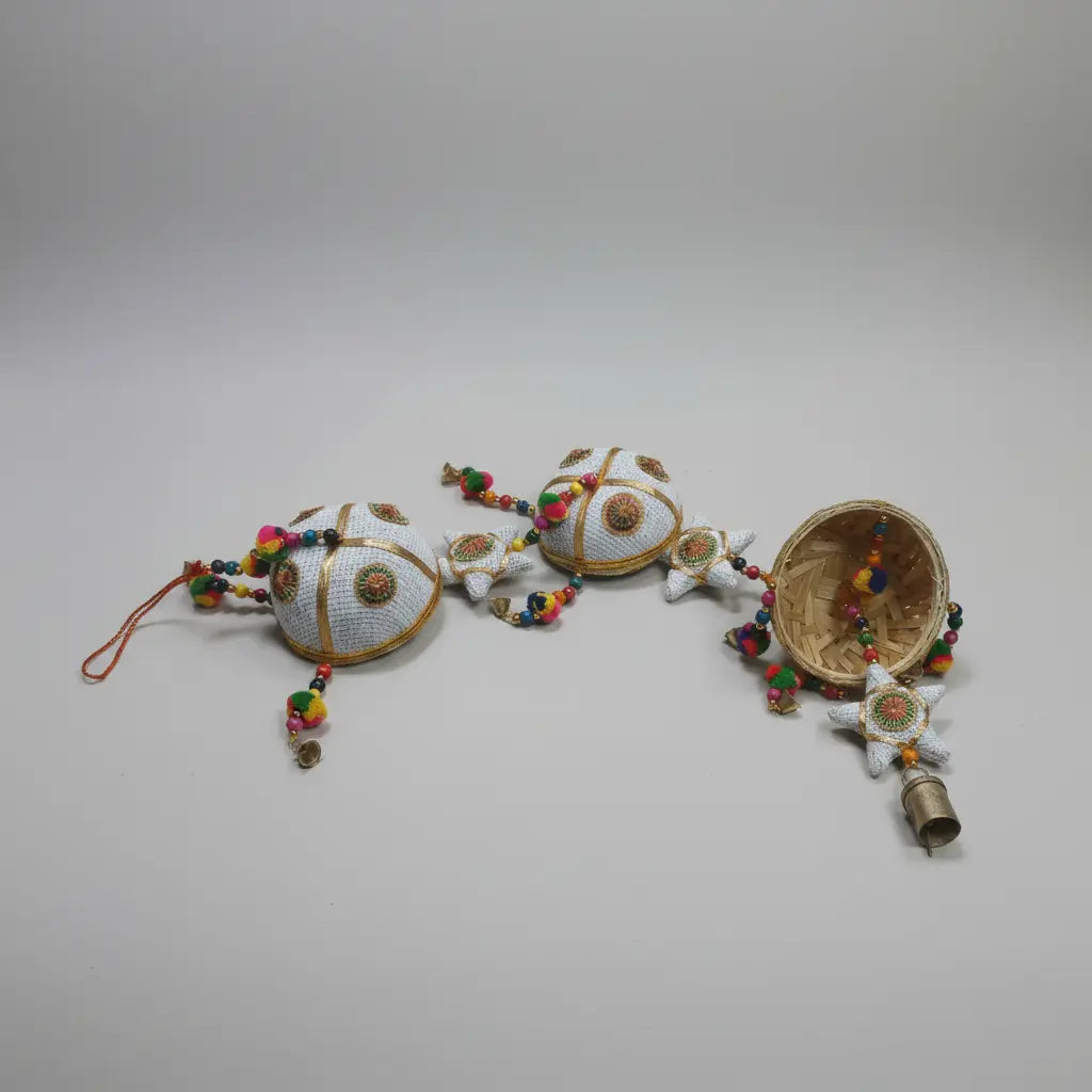 Closeup of Handmade Basket Wind Chime Showing Jali Cotton Texture, Multicolour Felt Beads and Small Hanging Brass Bells