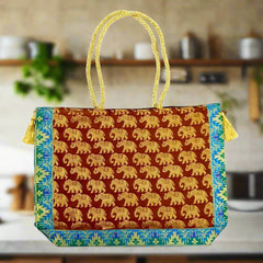 A handmade shoulder bag made of pure silk with golden tassels and fine zari work.