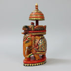 Close-up of fine-line brushwork and floral patterns on a 16cm wooden elephant idol.