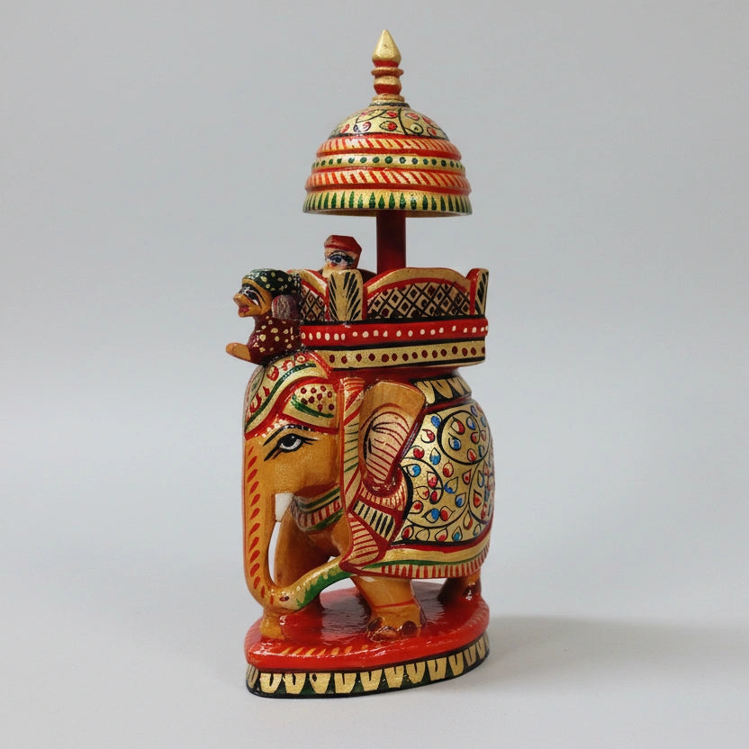 Close-up of fine-line brushwork and floral patterns on a 16cm wooden elephant idol.