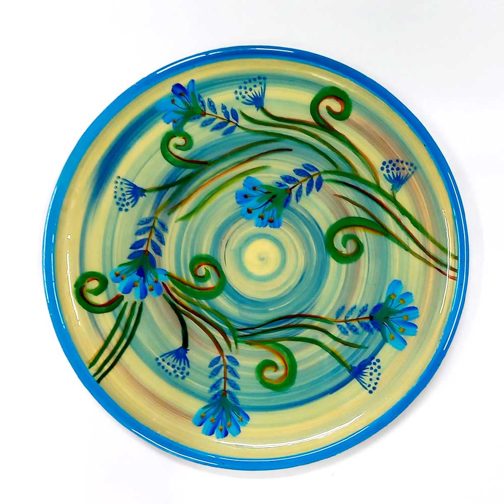 An Indian hand-painted wooden plate, a traditional piece of wall art.