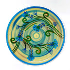 An Indian hand-painted wooden plate, a traditional piece of wall art.