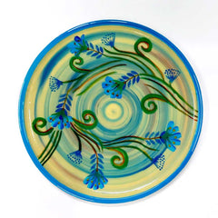 An Indian hand-painted wooden plate, a traditional piece of wall art.