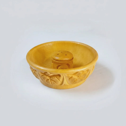 An Indian-style wooden incense holder with a traditional carving, perfect for a gift.