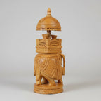 Close-up shot of the detailed hand-carving on a wooden Ambabari, highlighting the artisan craftsmanship.