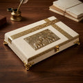 Closed ivory jute-covered wooden dry fruit box with a gold-tone twin-elephant panel, patterned borders and decorative feet