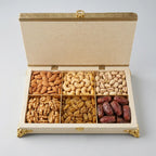 Open ivory jute-covered wooden box with six compartments displaying assorted dry fruits, shown for illustration only