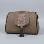 Close up of magnetic closure on a printed jacquard fabric crossbody bag