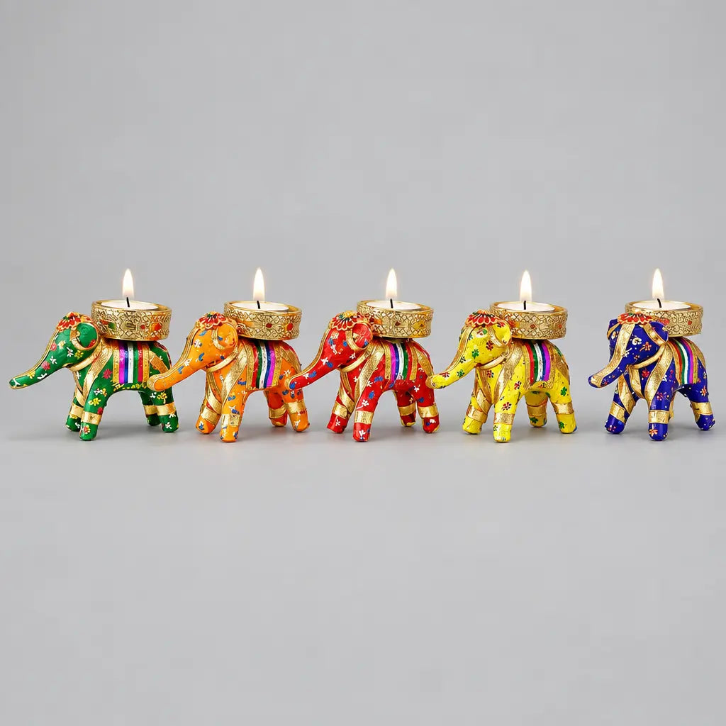 Close view of a handcrafted Jaipur elephant candle holder showing sequin work and lace border, lit for Diwali decor