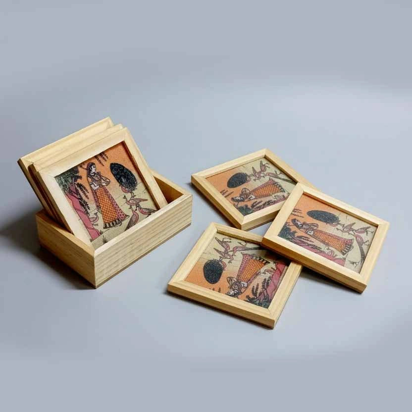 Stacked view of premium wooden tea coasters with traditional Bani Thani gemstone paintings in multicolors, ethnic home decor gift.