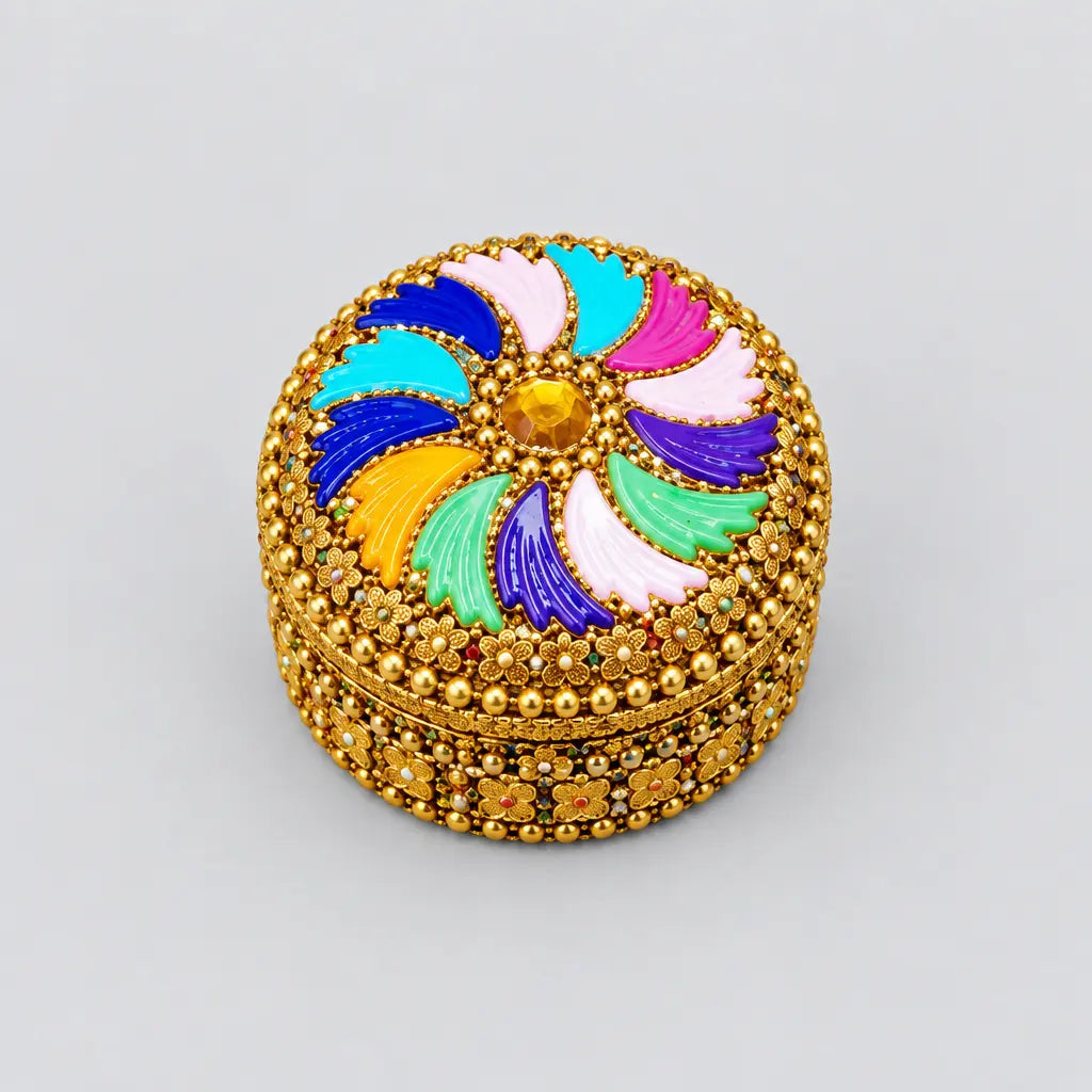 Closed kumkum box with a multicolour swirl design and gold-toned floral edging