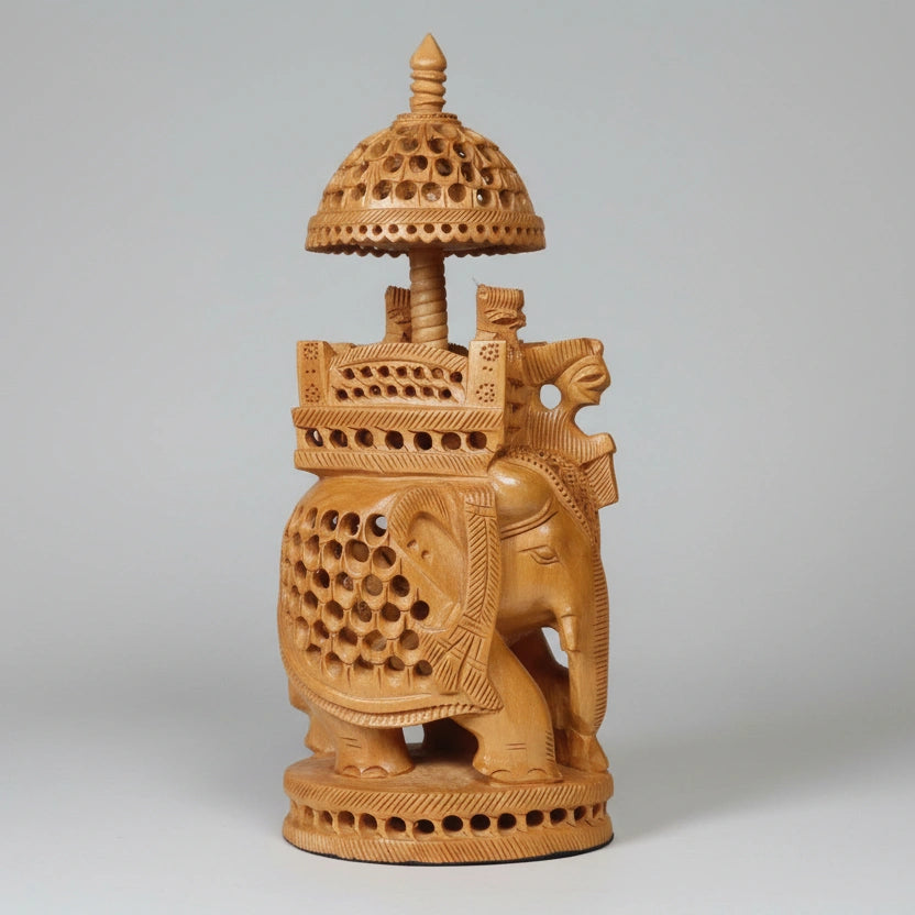 Detailed view of the royal King and Queen riding in an Ambari atop a lattice-carved elephant statue.