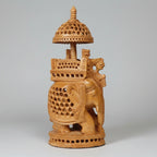 Detailed view of the royal King and Queen riding in an Ambari atop a lattice-carved elephant statue.