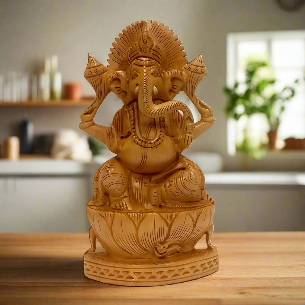 A beautiful Ganesh idol made of Kadamba wood, seated on a wooden lotus.
