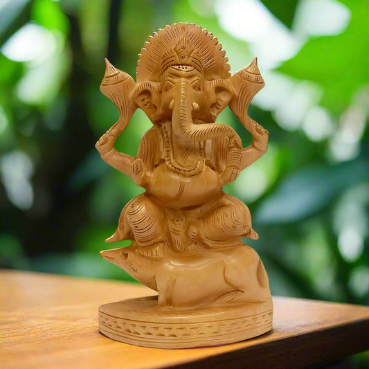 A magnificent Ganesh idol made from Kadamba wood, seated on a mouse with wonderful hand work.
