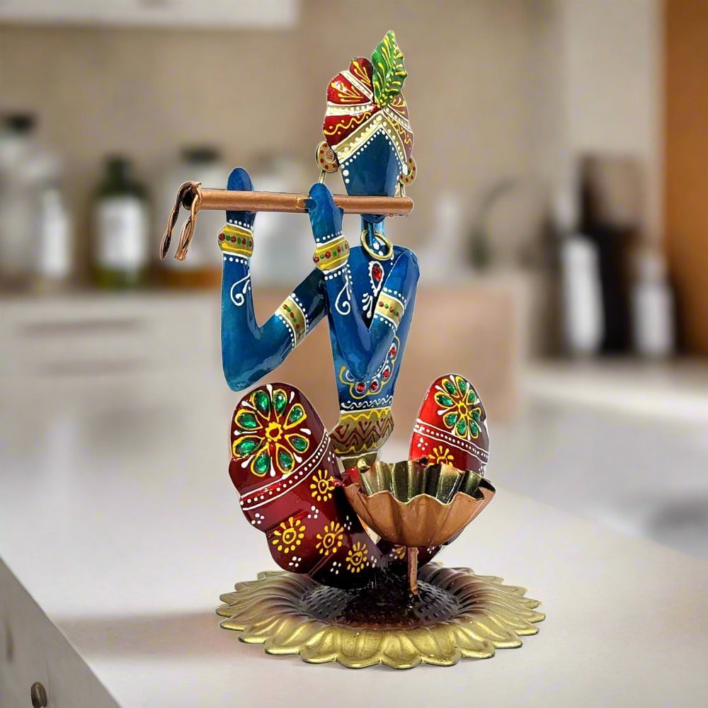 A metal Krishna idol with a bowl in front to hold a candle, perfect for gifting and decoration.