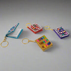 Handcrafted diary-shaped keyring made from lac with mirrors and beads.