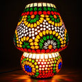 Illuminated mosaic glass table lamp with red flowers, green and yellow leaves, and a colourful rounded base