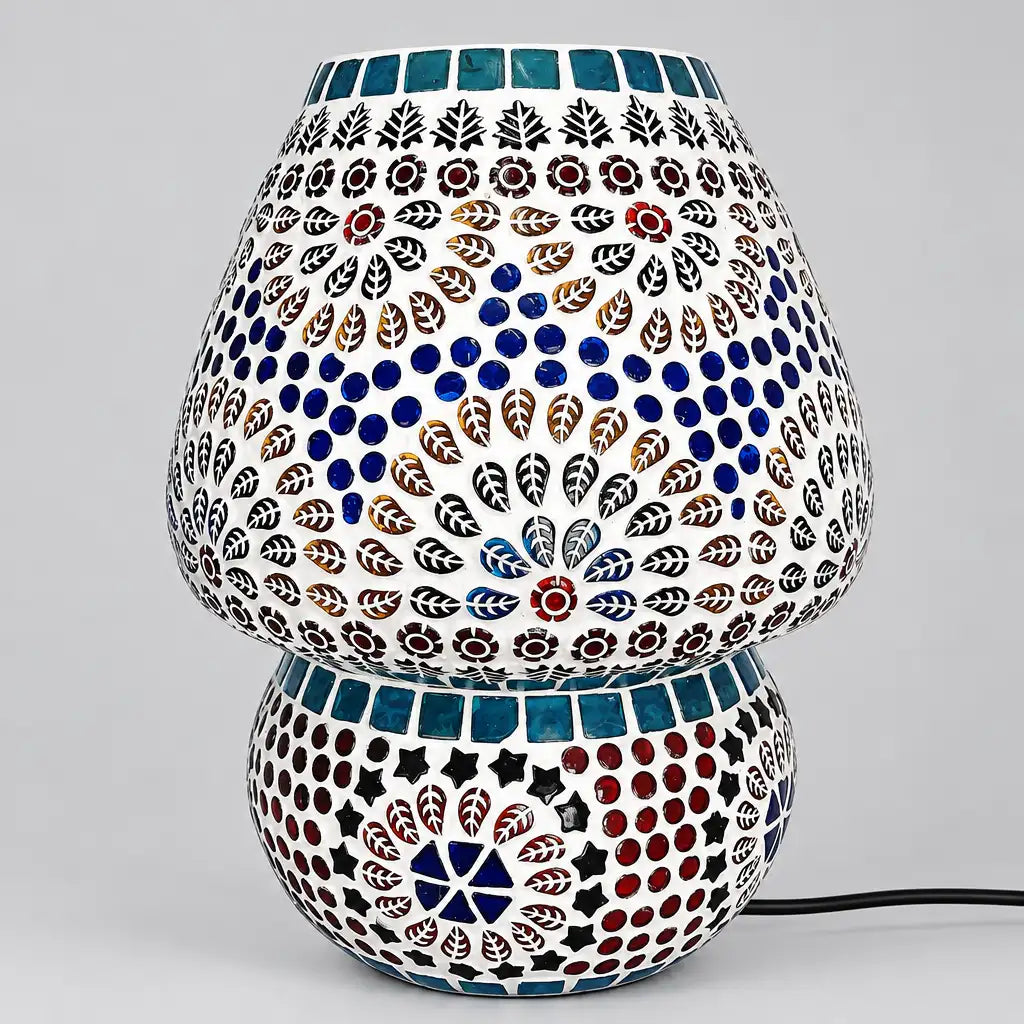 Unlit mosaic glass table lamp with floral and leaf motifs, blue circular accents, and a rounded patterned base