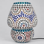 Unlit mosaic glass table lamp with floral and leaf motifs, blue circular accents, and a rounded patterned base