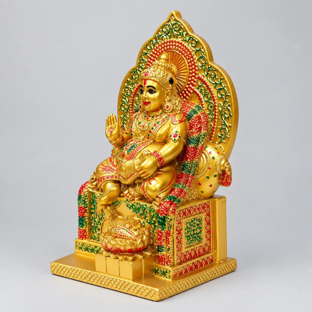 Lord Kuber statue viewed from the right, showing the crown, raised hand and ornate throne