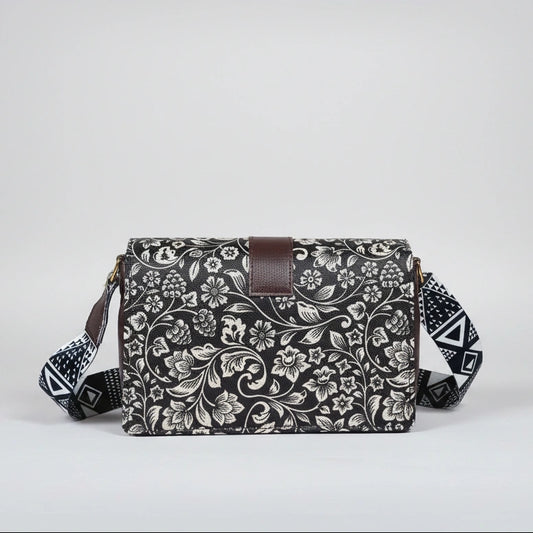Close-up of the intricate black and white botanical woven pattern and magnetic button closure.