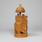 Detailed view of the royal howdah and decorative canopy on a wooden elephant statue.
