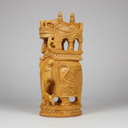 Detailed carving of a Mahout riding a royal elephant with intricate wood patterns.