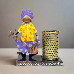 A cute pen holder and organizer with a metal figurine of a man wearing a turban.