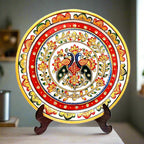 A hand-painted marble decorative plate with intricate details, including a wooden stand.