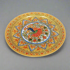 Luxurious marble plate adorned with detailed peacock painting and raised floral motifs, blending traditional craftsmanship with sophisticated design.