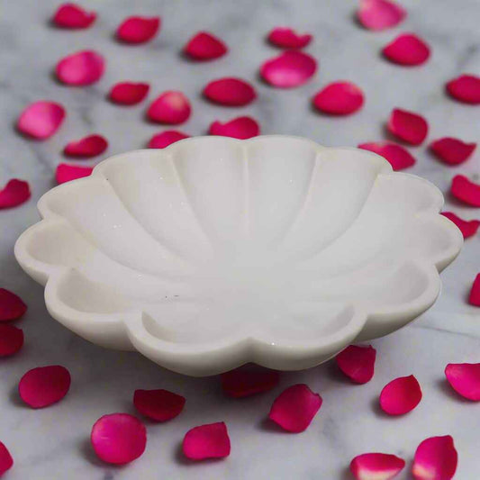 Round marble urli with candles and flowers for pooja décor