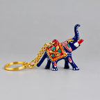 Blue Meenakari elephant keychain with a raised trunk, red floral saddle and gold-tone chain extending to the left