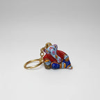 Metal Meenakari Ganesha keychain in a peaceful resting pose