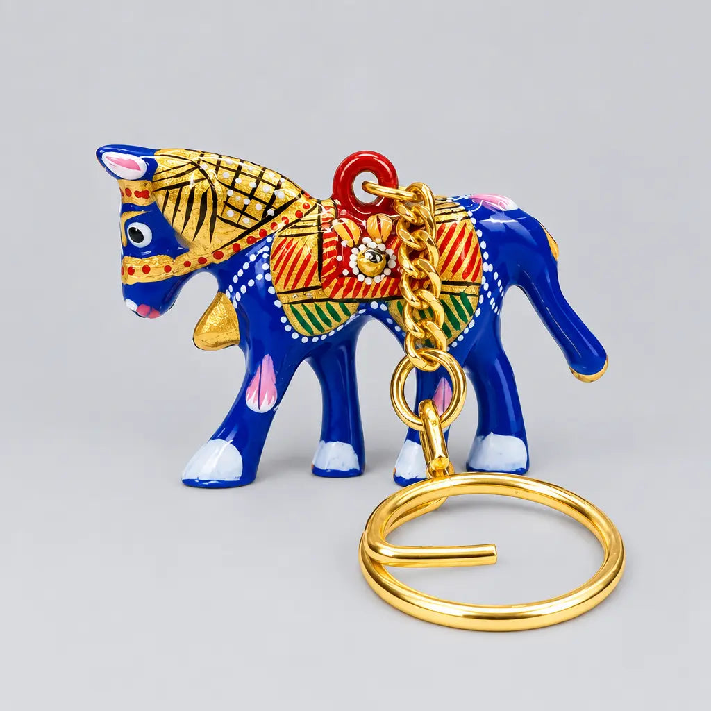 Blue Meenakari horse with red, green and gold-tone saddle detailing, with the key ring resting in front