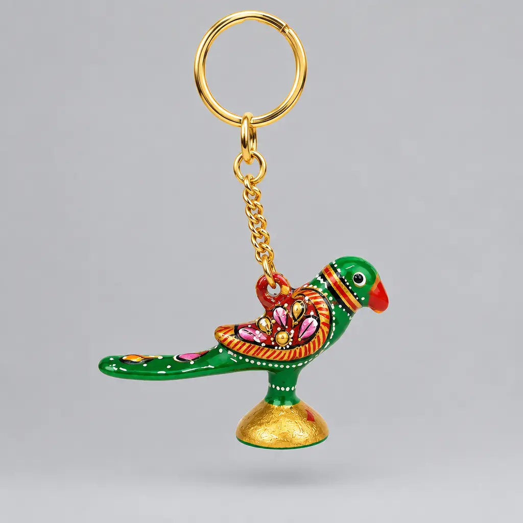 Green Meenakari parrot keychain with a red beak, floral wing detailing and a gold-tone ring hanging above
