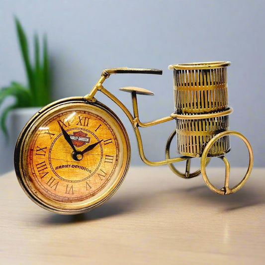 A metal bicycle pen holder with a clock attached to its wheel.