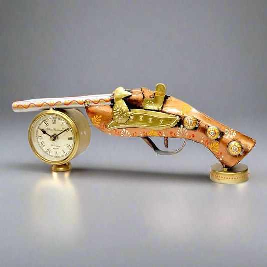 A metal showpiece with a gun motif and a clock, perfect for an office table.