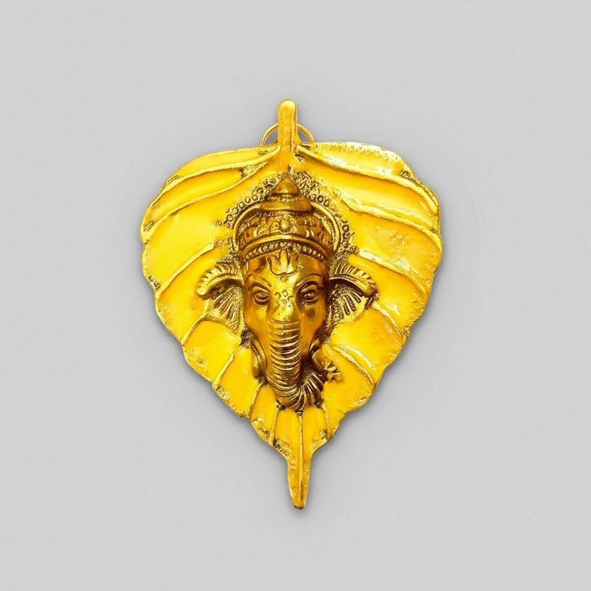 Vibrant metal leaf-shaped Ganesha wall decor with hand-painted enamel and golden polish.