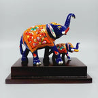 Meenakari mother elephant standing beside her baby on a wooden platform