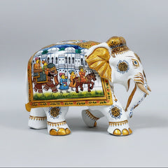 Close-up of hand-painted gold detailing on the trunk, ears, and nails of a white wooden elephant.