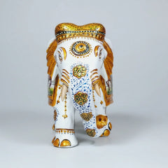 Decorative white wooden elephant placed in a modern living room as a luxury Rajasthani art piece.