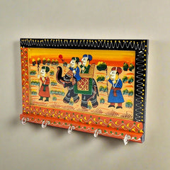 A wooden key stand with 5 hooks and a beautiful painting of Mughal kings.