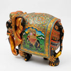 Rear angled view of Mughal miniature painted wooden elephant showing floral back patterns, a royal elephant scene and decorated legs