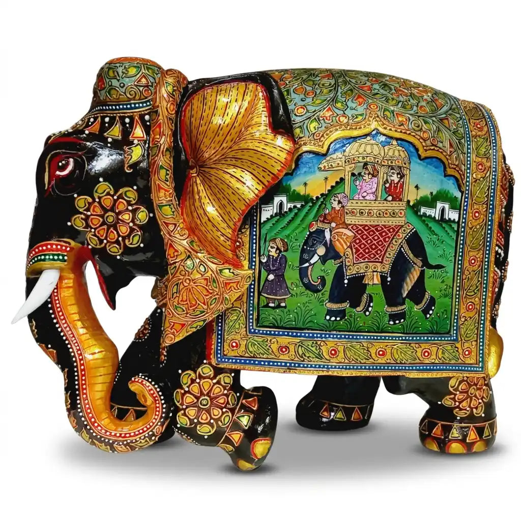 Left-facing Mughal miniature painted wooden elephant idol with a royal howdah scene, floral decoration and golden ears