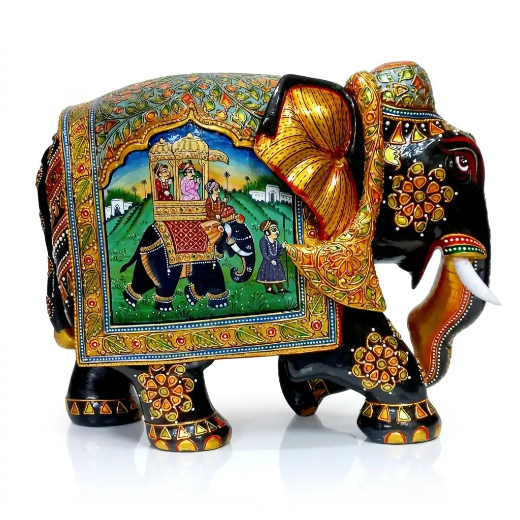 Right-facing black wooden elephant with a miniature painting of royal riders in a howdah and an attendant in a garden