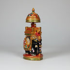 Close-up of pink, green, and red floral emboss painting on a golden painted base.